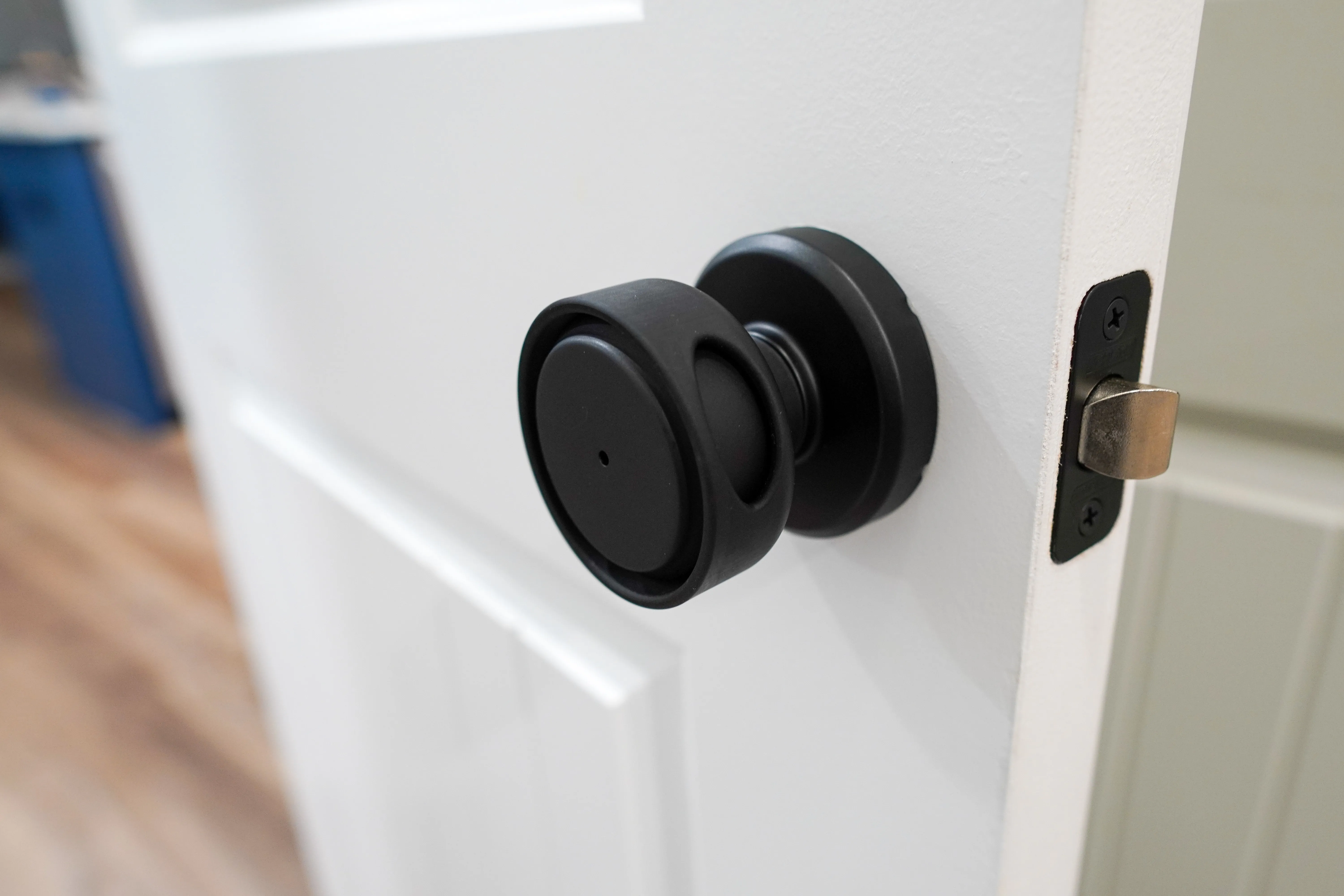 The printed cover installed on a Schlage Bowery knob, seen from the latch side of the door