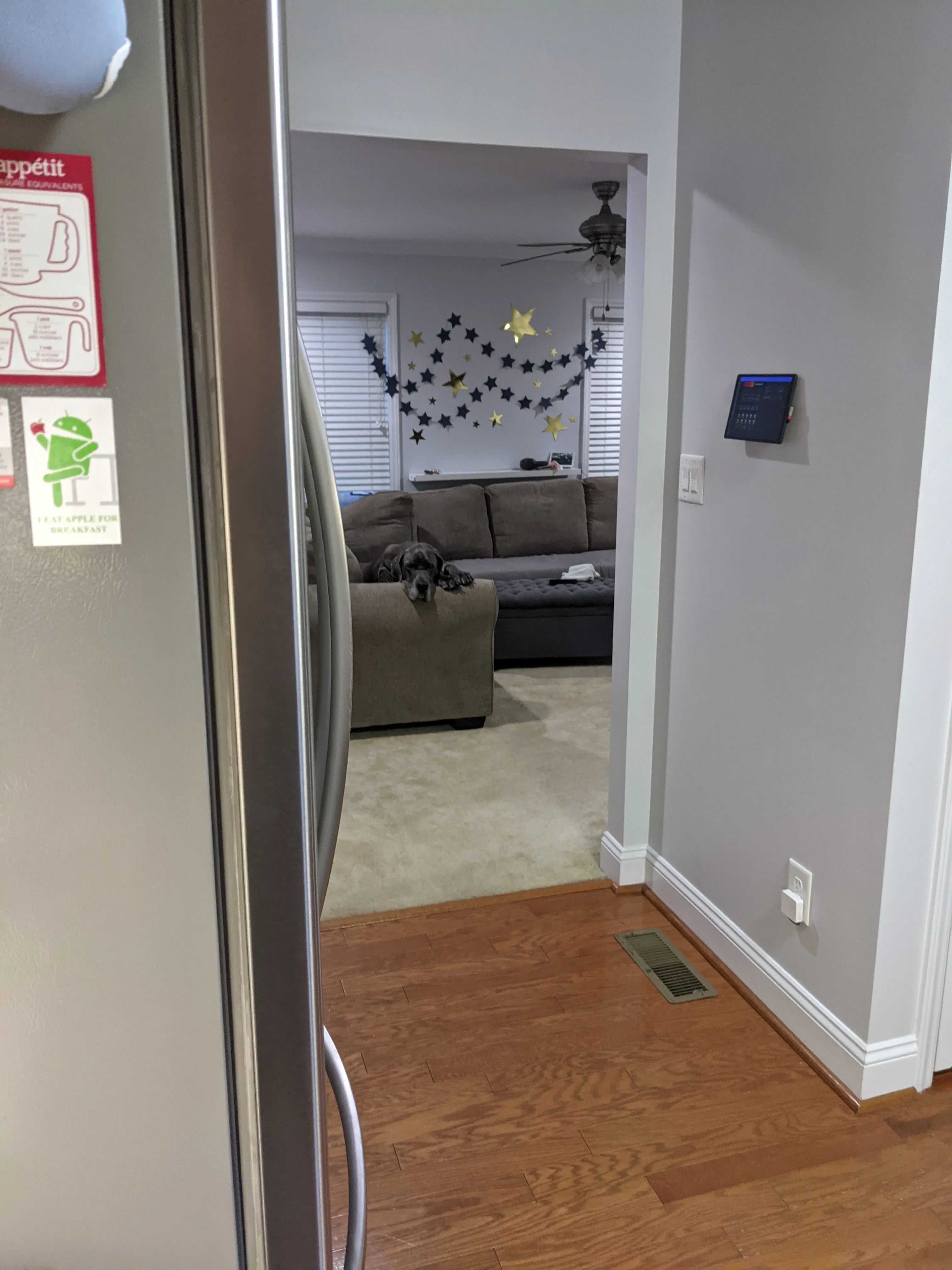 Tablet installed on a hallway wall running a dashboard